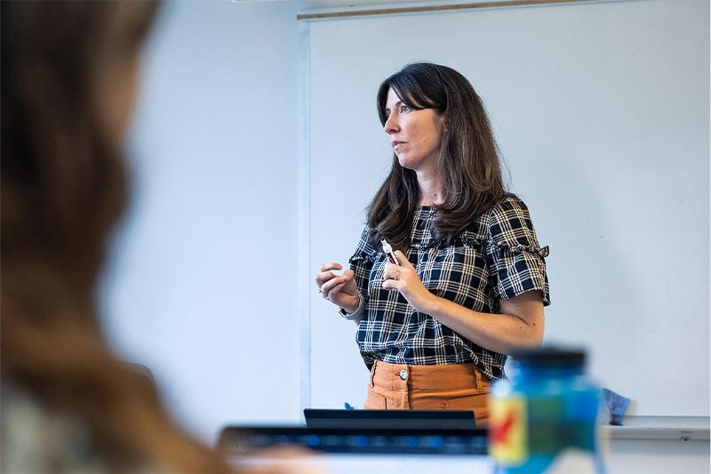 Francesca Tripodi teaching in front of a whiteboard.